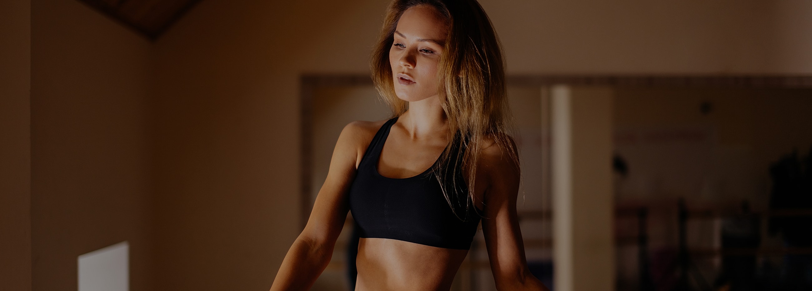 Woman exercising in a gym environment.